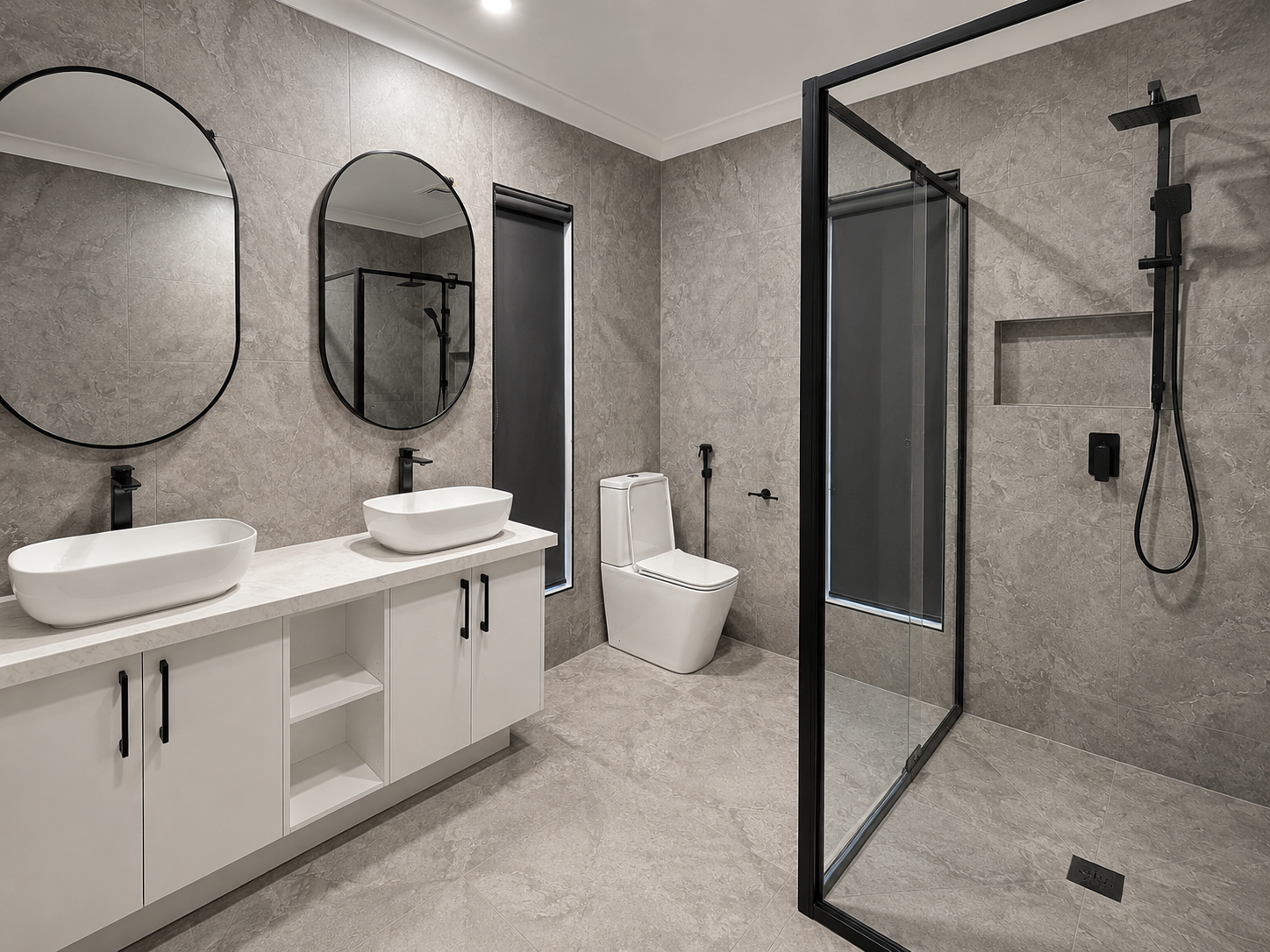 Modern bathroom renovation in Cranbourne by WFixit with double vanity, LED mirrors, black framed shower and grey tiles
